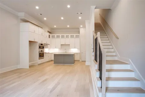 a view of kitchen with cabinets and wooden floor