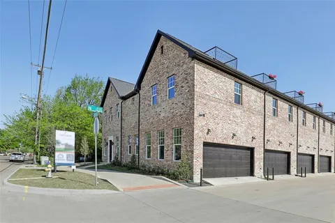 a kitchen with stainless steel appliances a sink a stove a refrigerator and cabinets