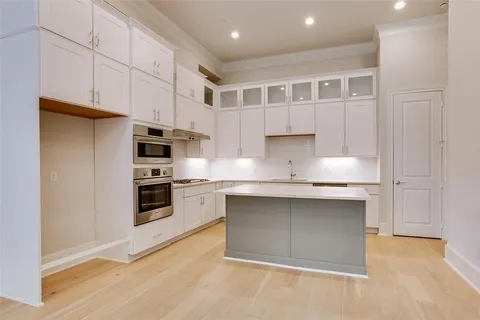 a kitchen with stainless steel appliances granite countertop a stove and a sink