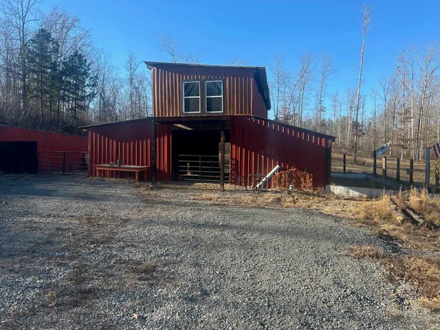a view of a house with a yard and wooden fence
