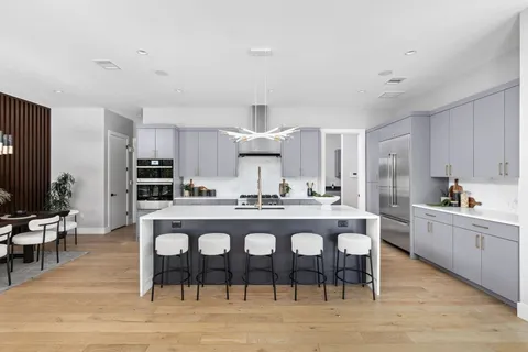 a large kitchen with a table and chairs