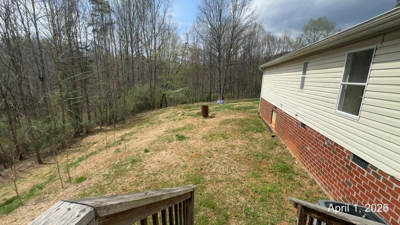 108 Cherokee Lane Thaxton, VA 24174 - Photo 14 of 15 a backyard of a house with large trees