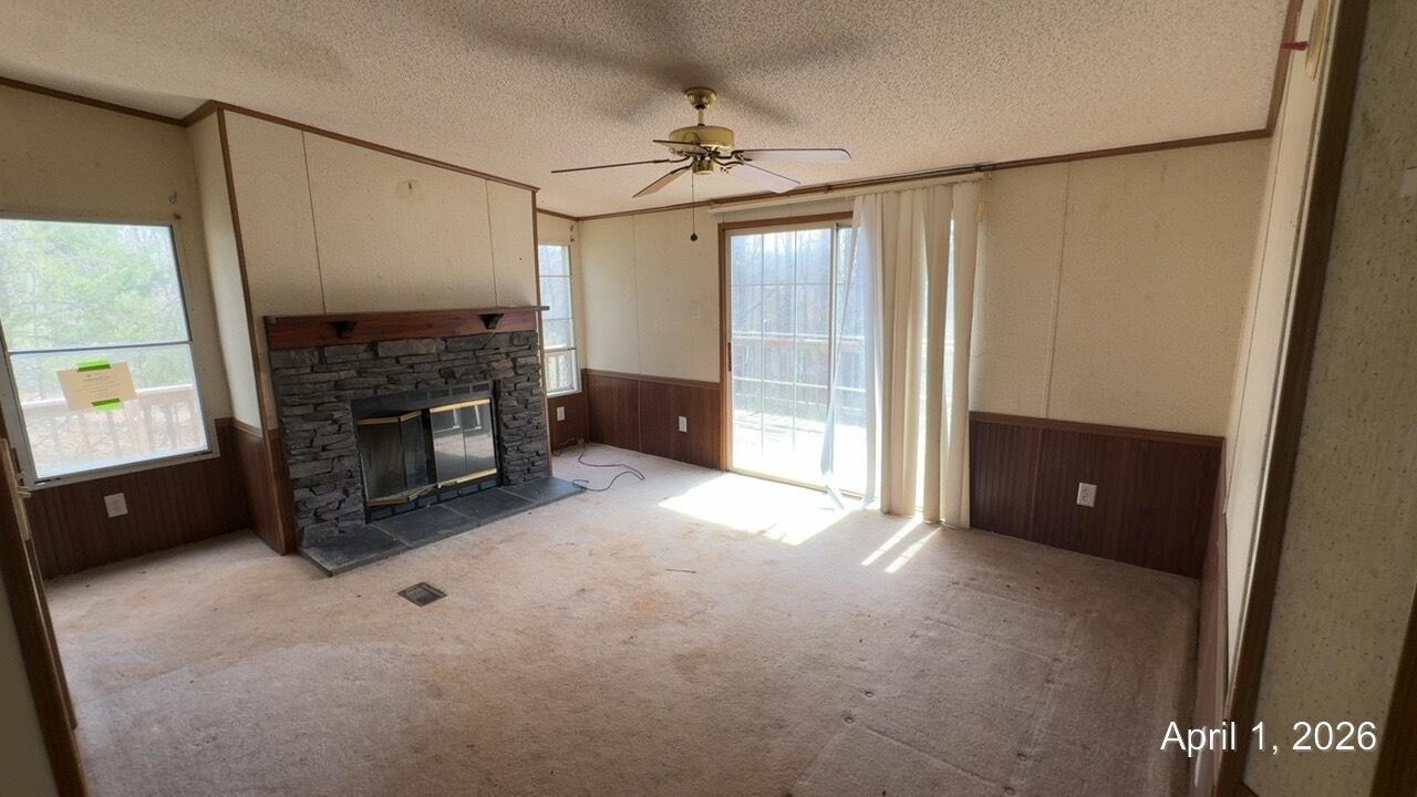 108 Cherokee Lane Thaxton, VA 24174 - Photo 2 of 15 a view of an empty room with a fireplace and a window