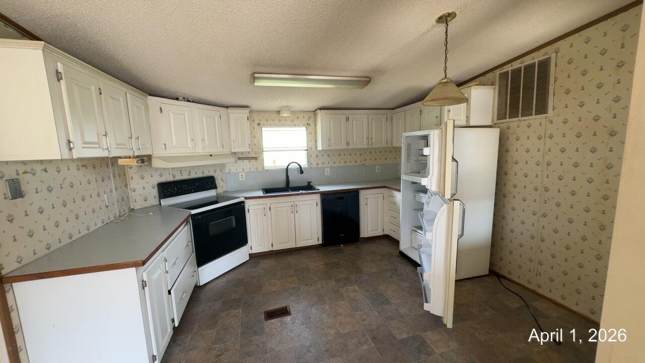 108 Cherokee Lane Thaxton, VA 24174 - Photo 3 of 15 a kitchen with stainless steel appliances a refrigerator sink and cabinets
