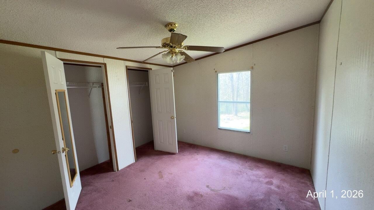 108 Cherokee Lane Thaxton, VA 24174 - Photo 8 of 15 an empty room with windows and fan
