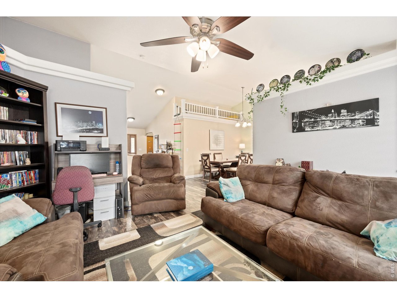 84 Pike Lane Severance, CO 80550 - Photo 16 of 34 a living room with furniture kitchen view and a chandelier