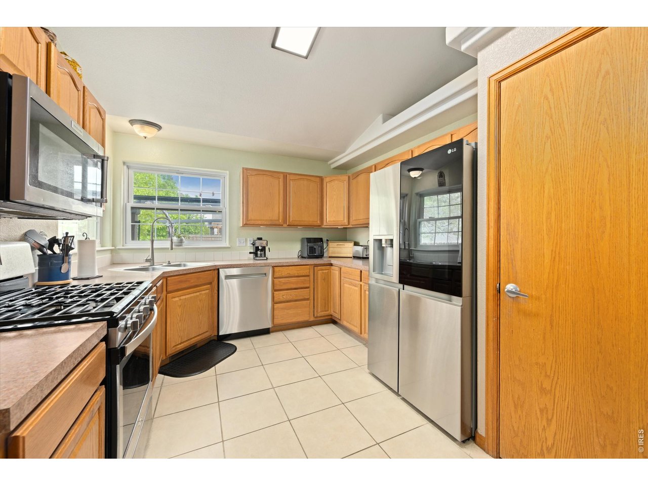 84 Pike Lane Severance, CO 80550 - Photo 22 of 34 a kitchen with a stove a sink dishwasher a refrigerator and cabinets