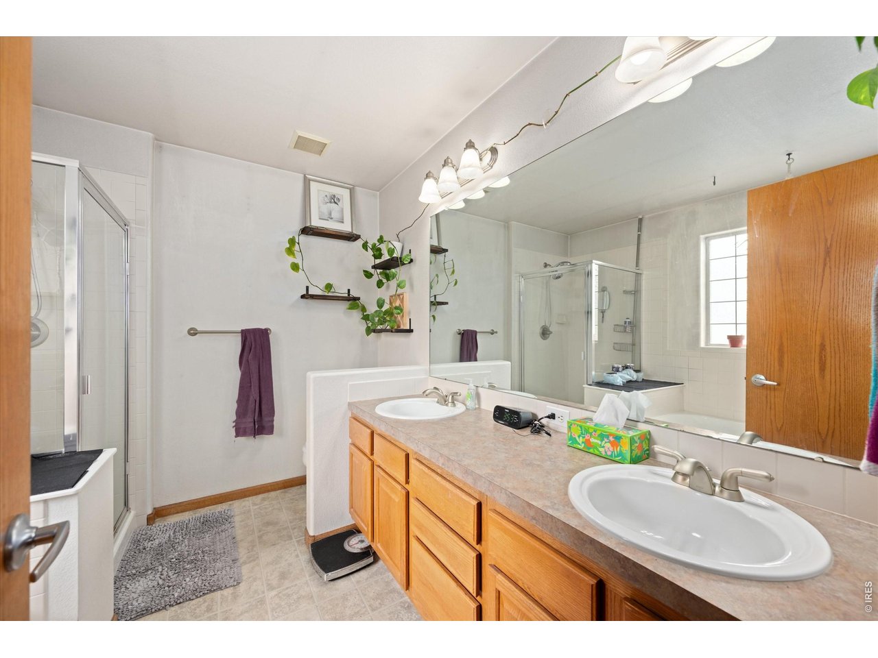 84 Pike Lane Severance, CO 80550 - Photo 25 of 34 a bathroom with a sink double vanity and a mirror