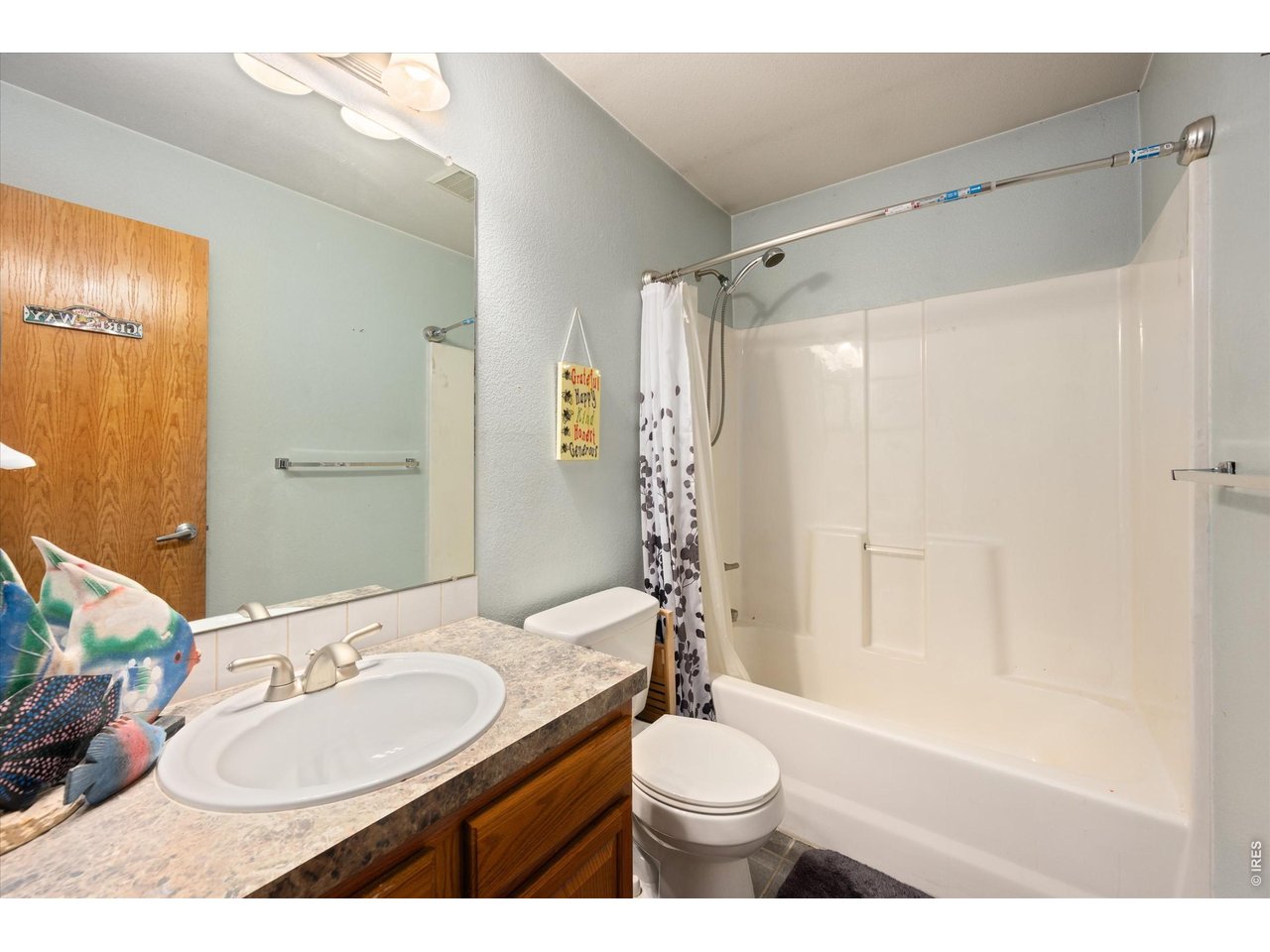 84 Pike Lane Severance, CO 80550 - Photo 28 of 34 a bathroom with a sink toilet a mirror and shower