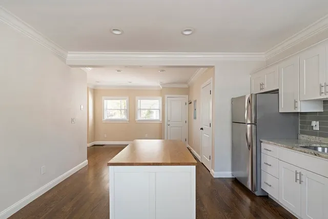 a kitchen with a refrigerator sink and cabinets