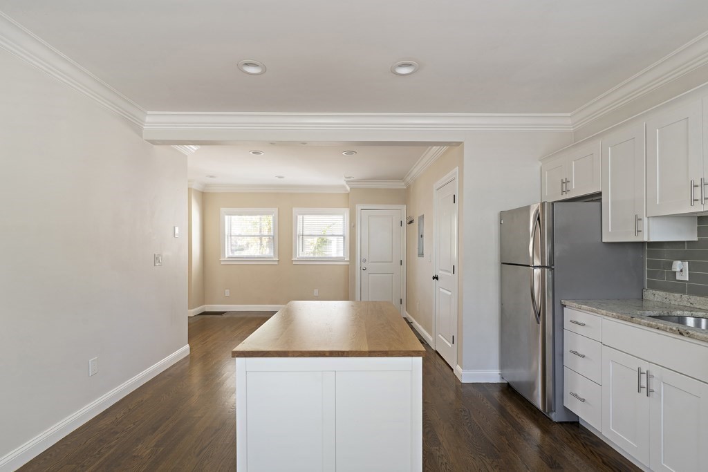47 Notre Dame Street, Unit 1 Boston, MA 02119 - Photo 6 of 11 a kitchen with a refrigerator sink and cabinets