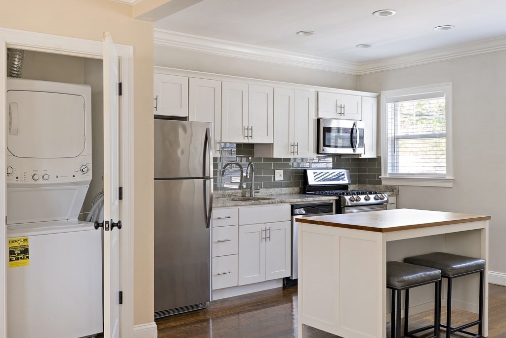 47 Notre Dame Street, Unit 1 Boston, MA 02119 - Photo 7 of 11 a kitchen with stainless steel appliances a refrigerator sink and cabinets