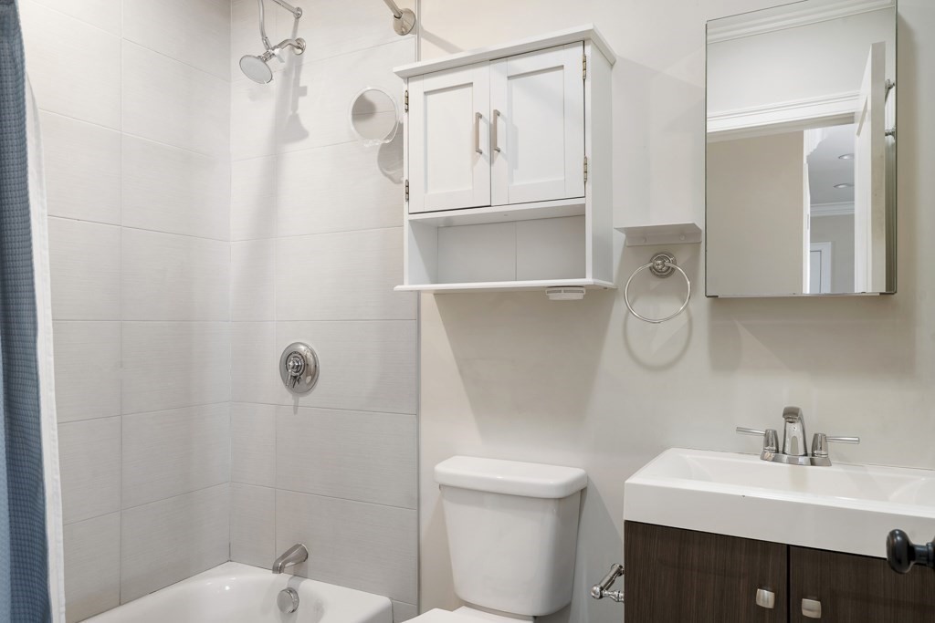 47 Notre Dame Street, Unit 1 Boston, MA 02119 - Photo 10 of 11 a bathroom with a sink a toilet and shower