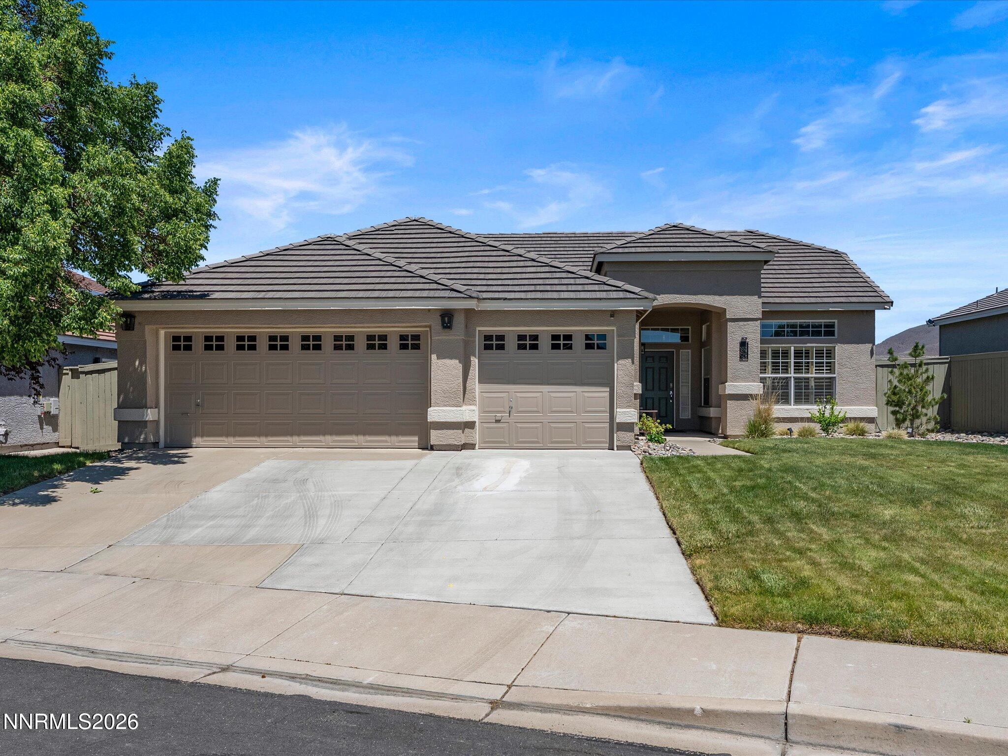 1275 Bernwood Court Reno, NV 89521 - Photo 1 of 19 a front view of a house with a garden