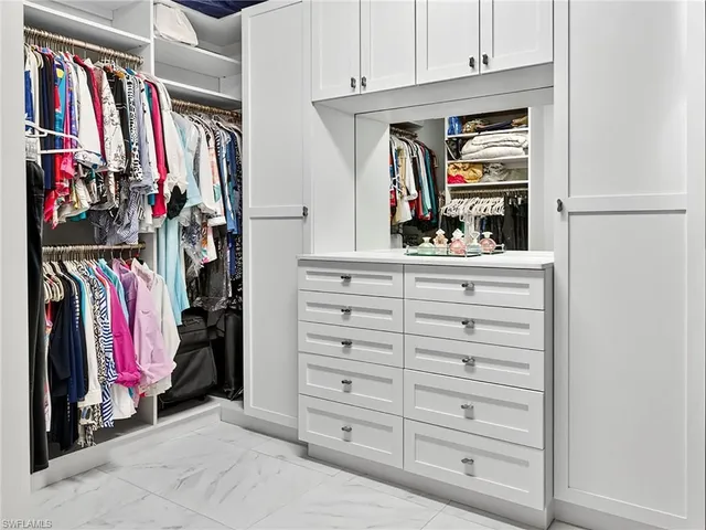 a view of a houses with a yard and a large tree