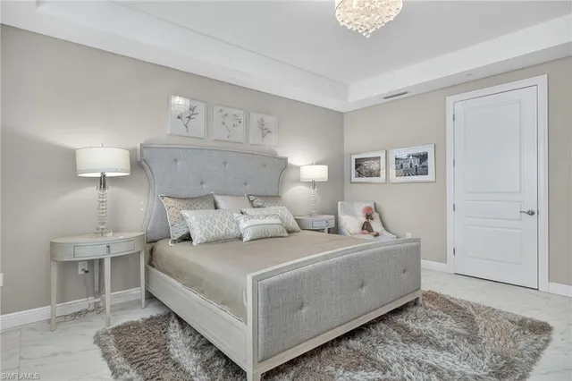 a view of a swimming pool with lawn chairs and plants