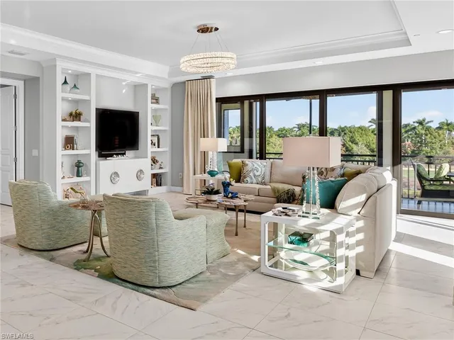 a kitchen with stainless steel appliances granite countertop a stove top oven a sink dishwasher a dining table and chairs with wooden floor