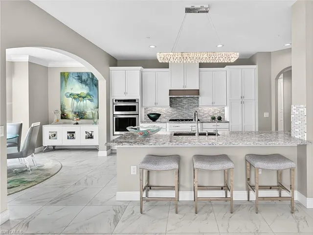 a view of a dining room with furniture a chandelier and wooden floor
