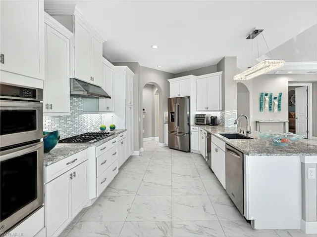 a bathroom with a granite countertop double vanity sink and mirror