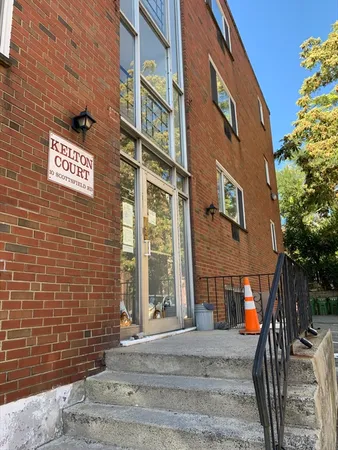a view of a brick building with many windows