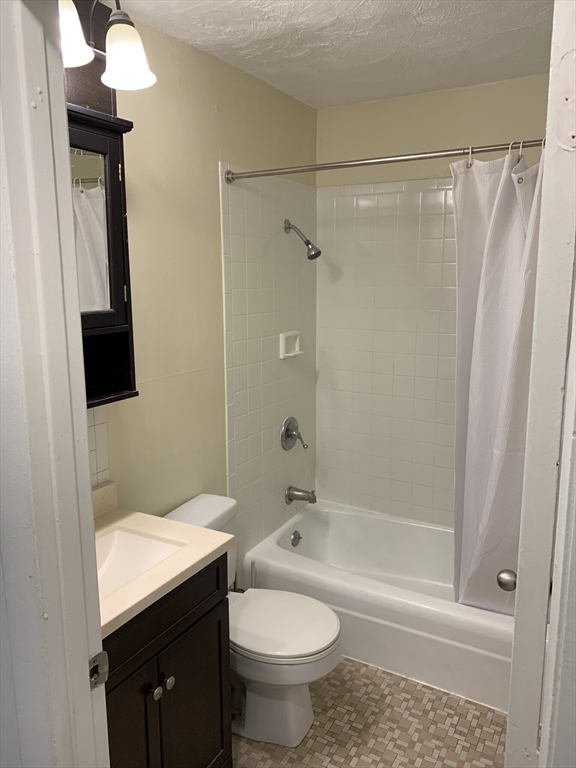 10 Scottfield Road, Unit B3 Boston, MA 02134 - Photo 7 of 15 a bathroom with a sink a toilet and shower