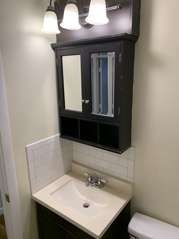 10 Scottfield Road, Unit B3 Boston, MA 02134 - Photo 8 of 15 a bathroom with a sink and a mirror