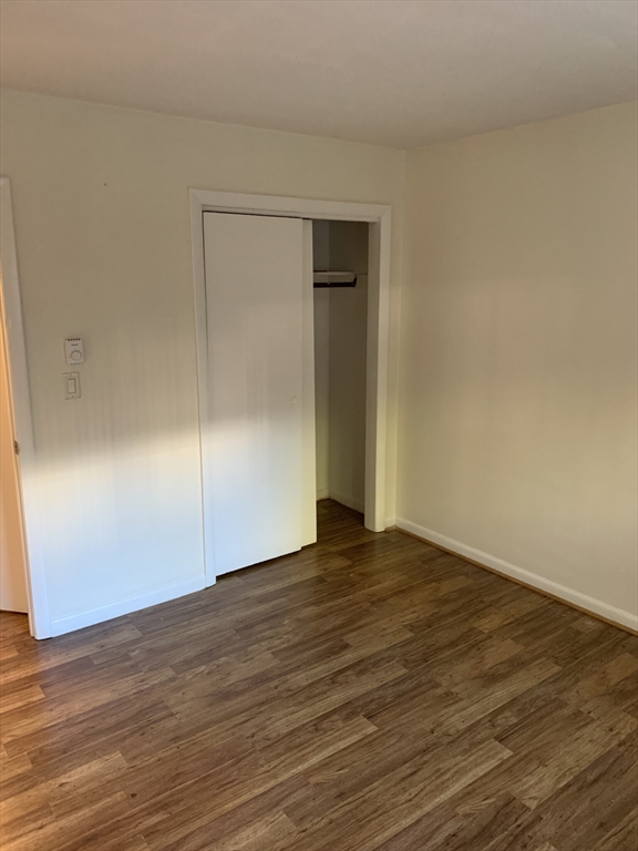 10 Scottfield Road, Unit B3 Boston, MA 02134 - Photo 10 of 15 a view of an empty room with wooden floor and closet