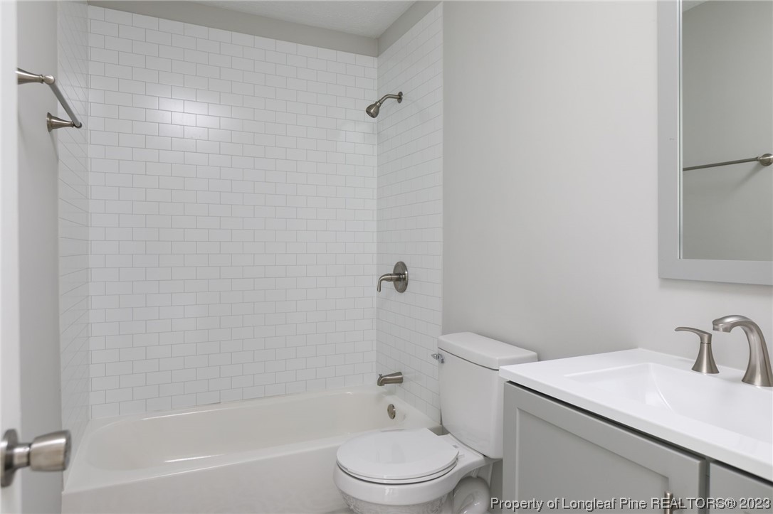 942 Rim Road Fayetteville, NC 28314 - Photo 11 of 14 a bathroom with a sink toilet and shower