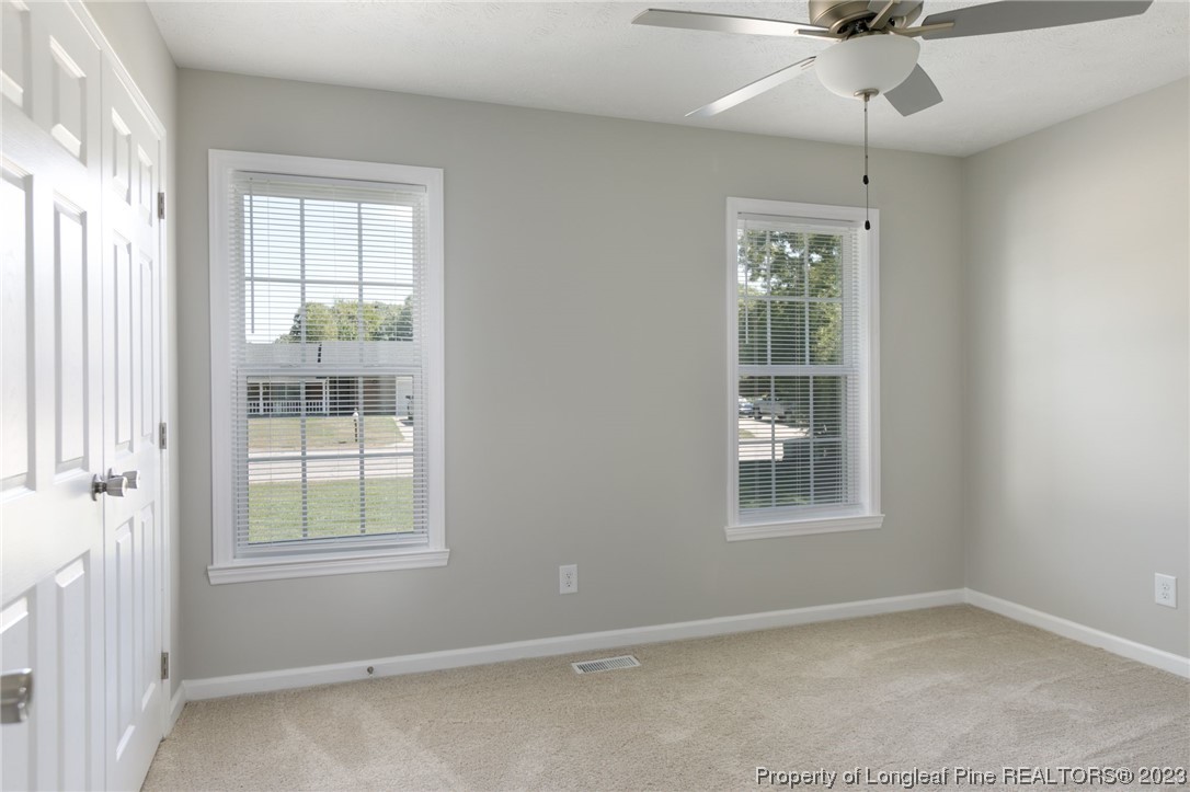 942 Rim Road Fayetteville, NC 28314 - Photo 12 of 14 an empty room with a window and a fan