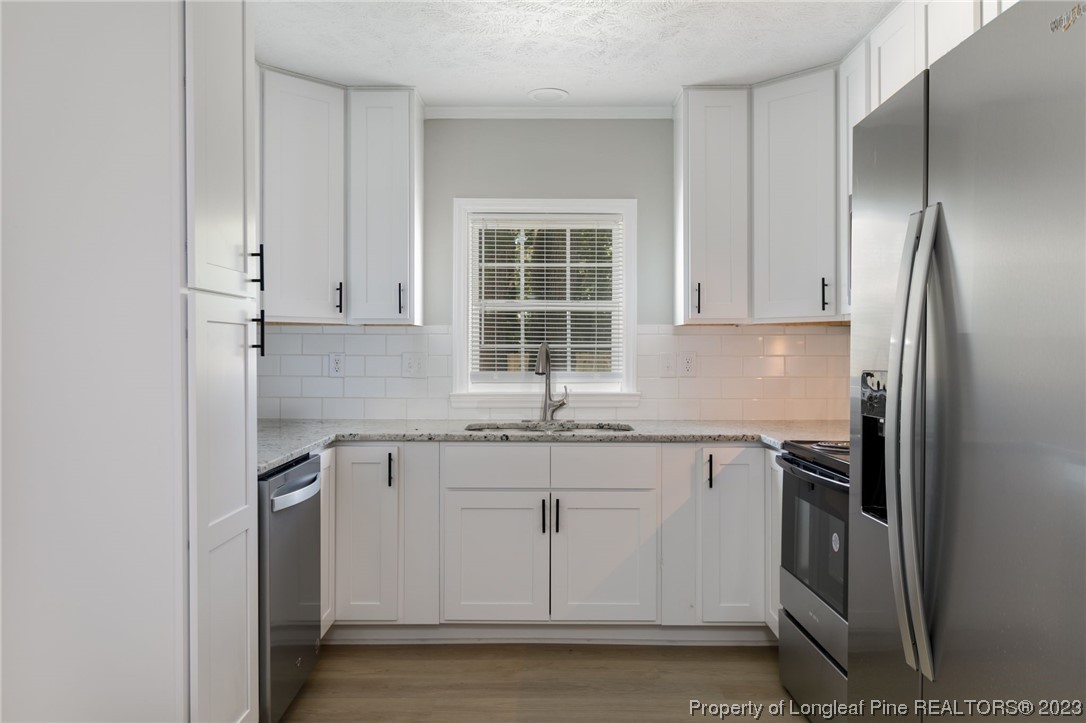 942 Rim Road Fayetteville, NC 28314 - Photo 2 of 14 a kitchen with stainless steel appliances granite countertop a refrigerator and a sink