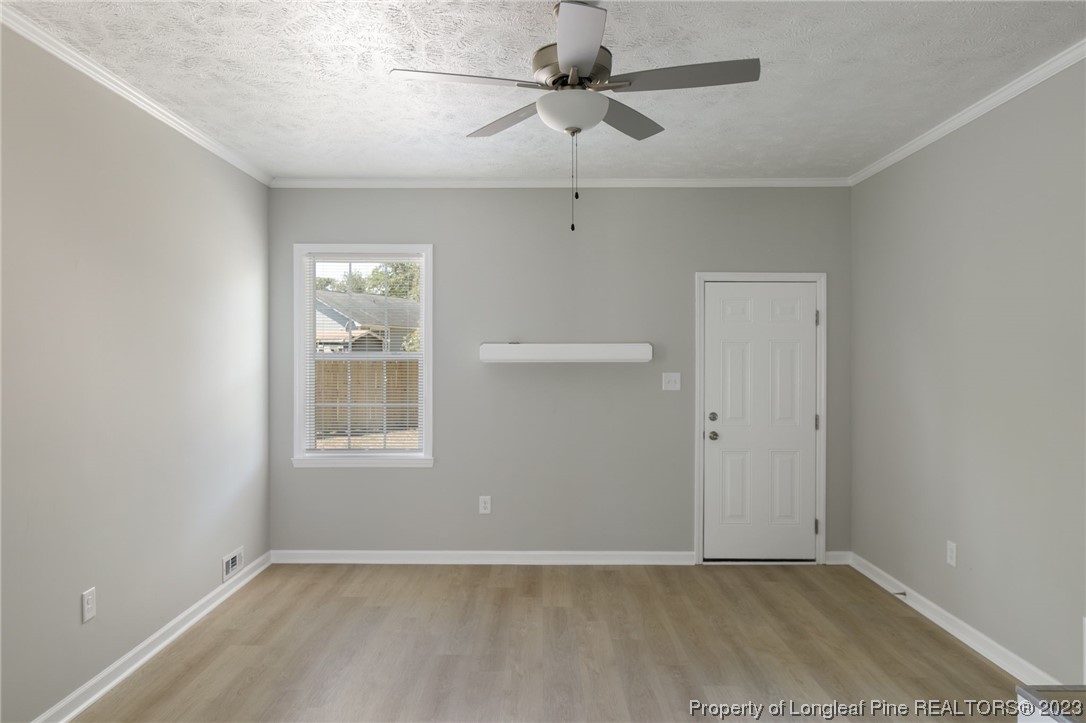 942 Rim Road Fayetteville, NC 28314 - Photo 4 of 14 an empty room with windows and fan