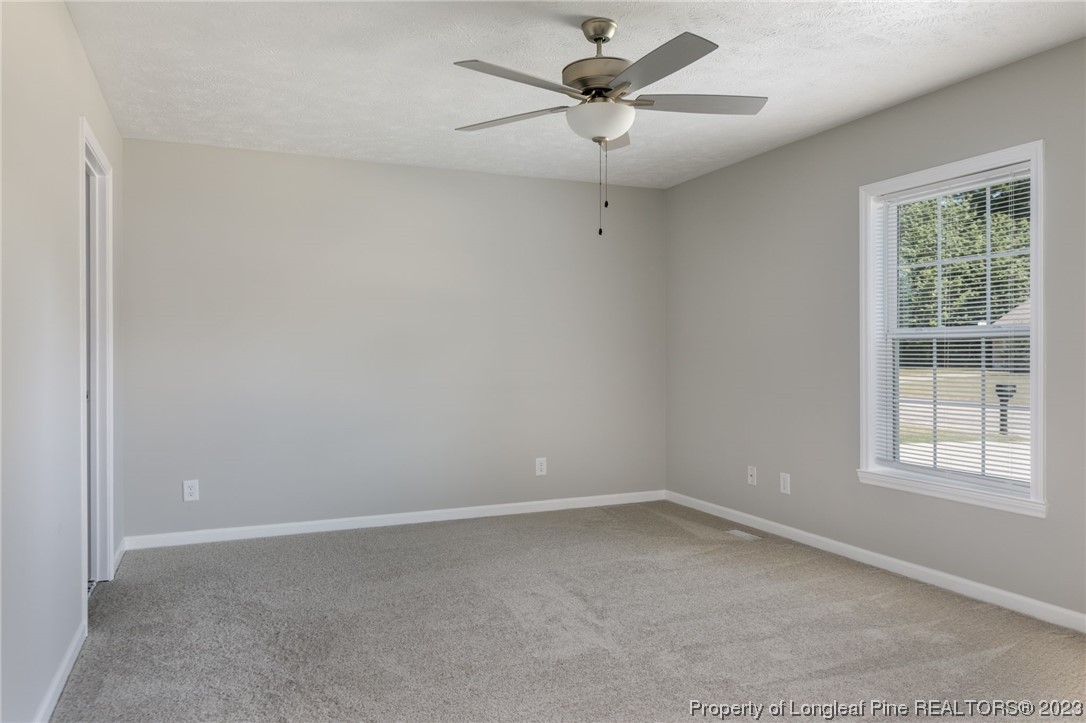 942 Rim Road Fayetteville, NC 28314 - Photo 6 of 14 an empty room with a window and a fan
