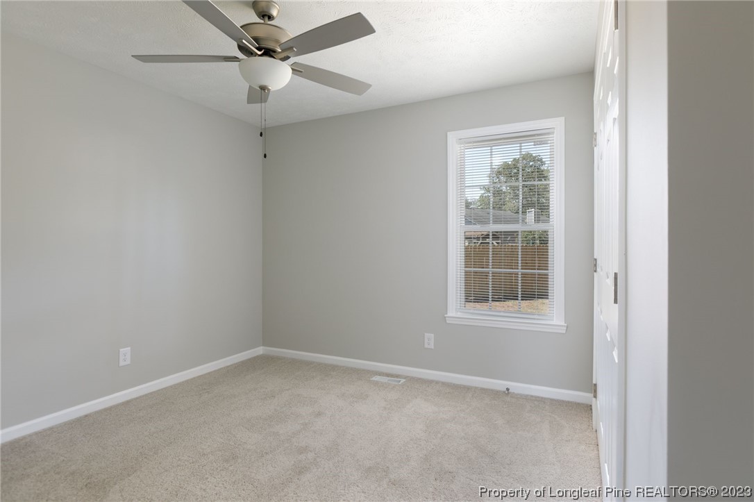 942 Rim Road Fayetteville, NC 28314 - Photo 10 of 14 an empty room with a window and ceiling fan