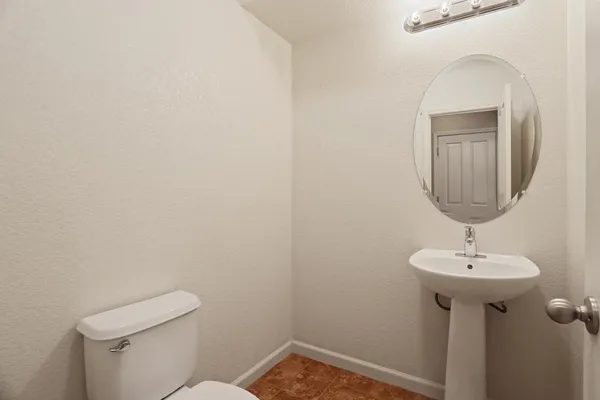 a bathroom with a sink toilet and mirror