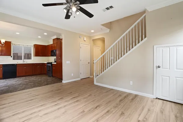 a view of a livingroom with wooden floor and stairs