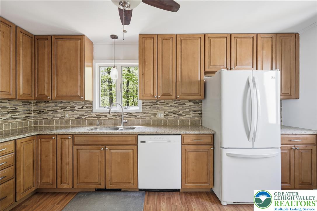 505 Chipmunk Road Bushkill, PA 18324 - Photo 8 of 46 a kitchen with a white cabinets and white appliances
