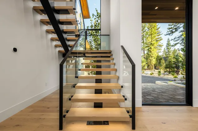 a view of staircase with white walls and a window