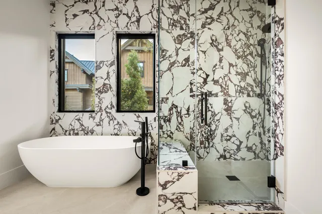 a bathroom with a bathtub and shower