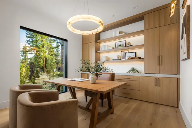 a kitchen with a sink and chairs