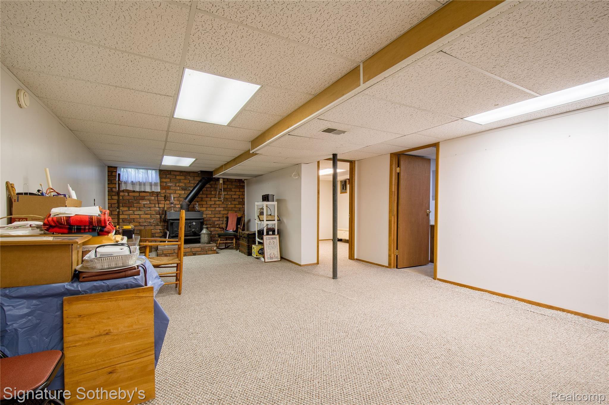 2500 South Hickory Ridge Road Milford, MI 48380 - Photo 19 of 40 Spacious finished basement with wood burning stove