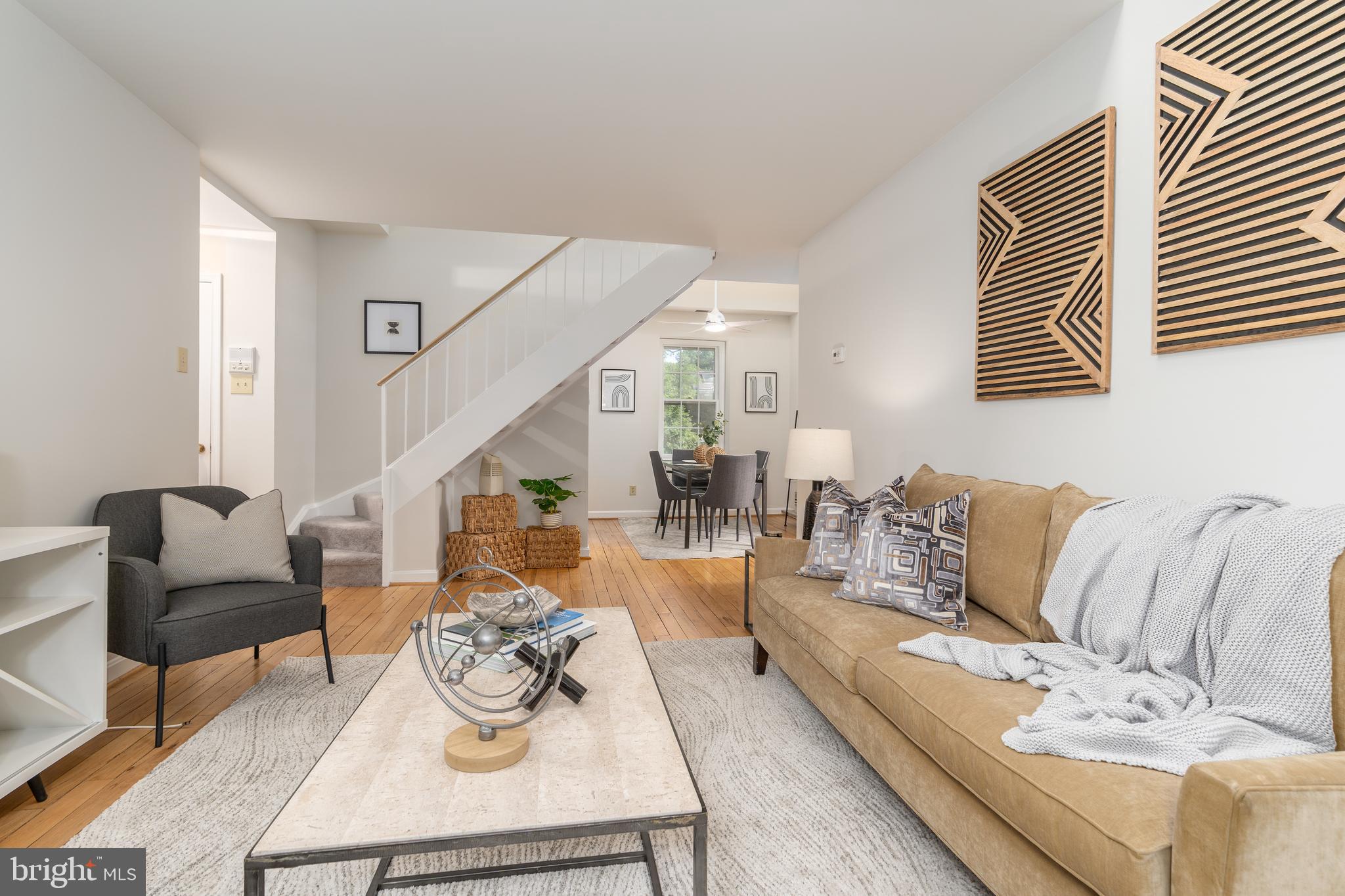 3640 39th Street Northwest, Unit E527 Washington, DC 20016 - Photo 1 of 24 a living room with furniture and wooden floor
