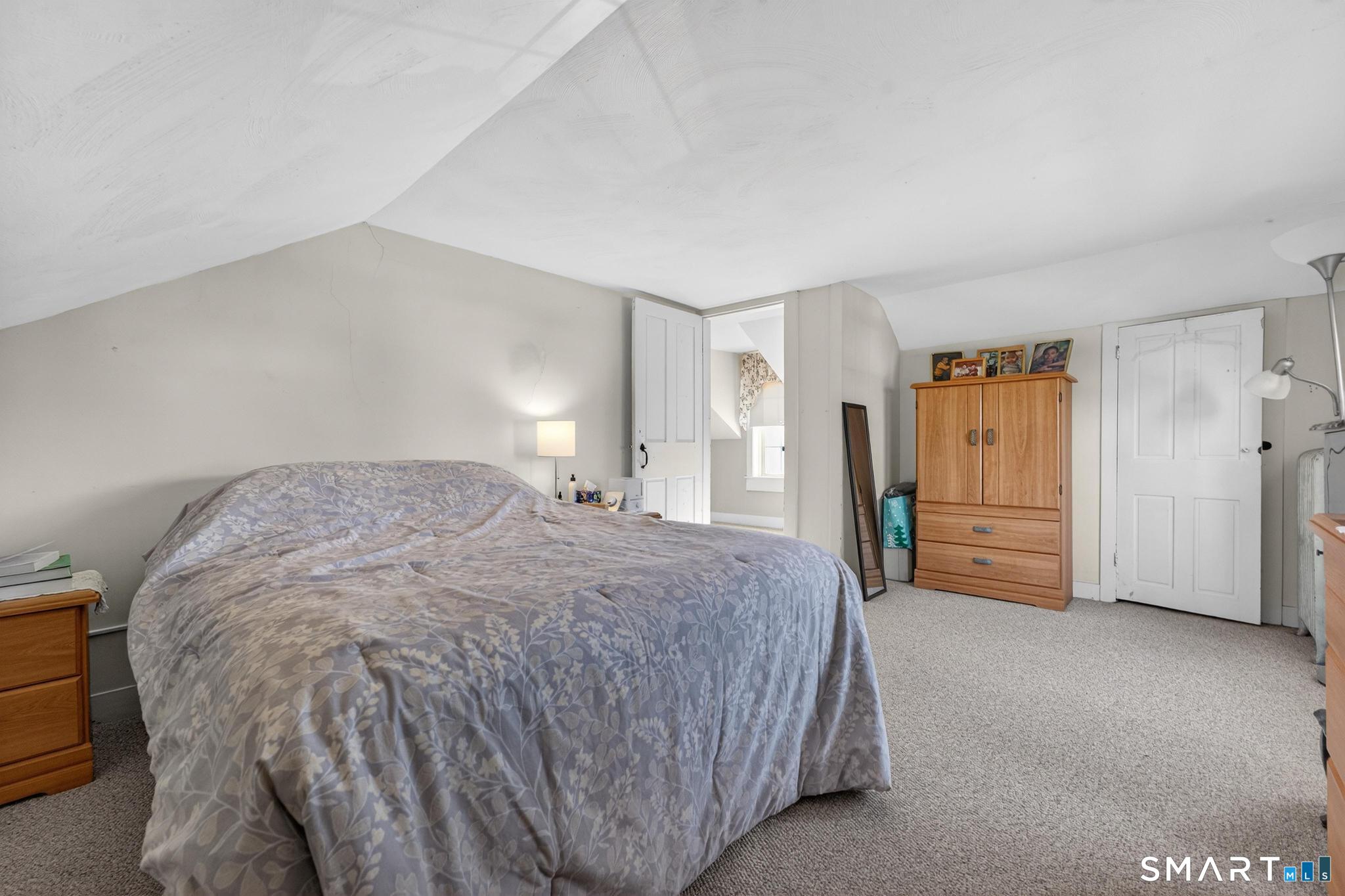 18 Broad Street Danielson, CT 06239 - Photo 15 of 38 a spacious bedroom with a bed and a cabinets