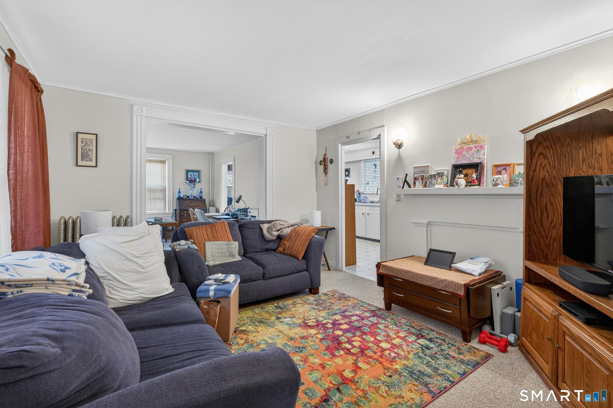 18 Broad Street Danielson, CT 06239 - Photo 19 of 38 a living room with furniture a rug and a flat screen tv
