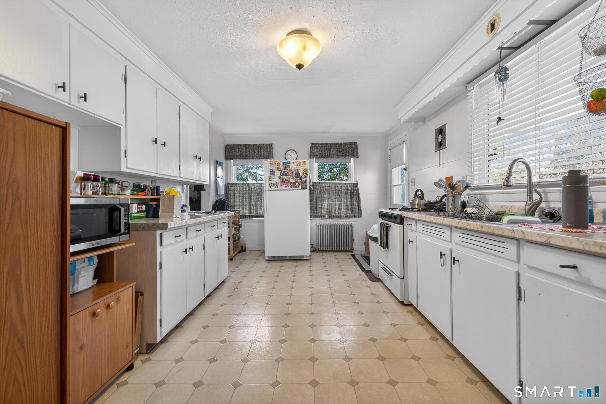 18 Broad Street Danielson, CT 06239 - Photo 24 of 38 a kitchen with refrigerator and cabinets