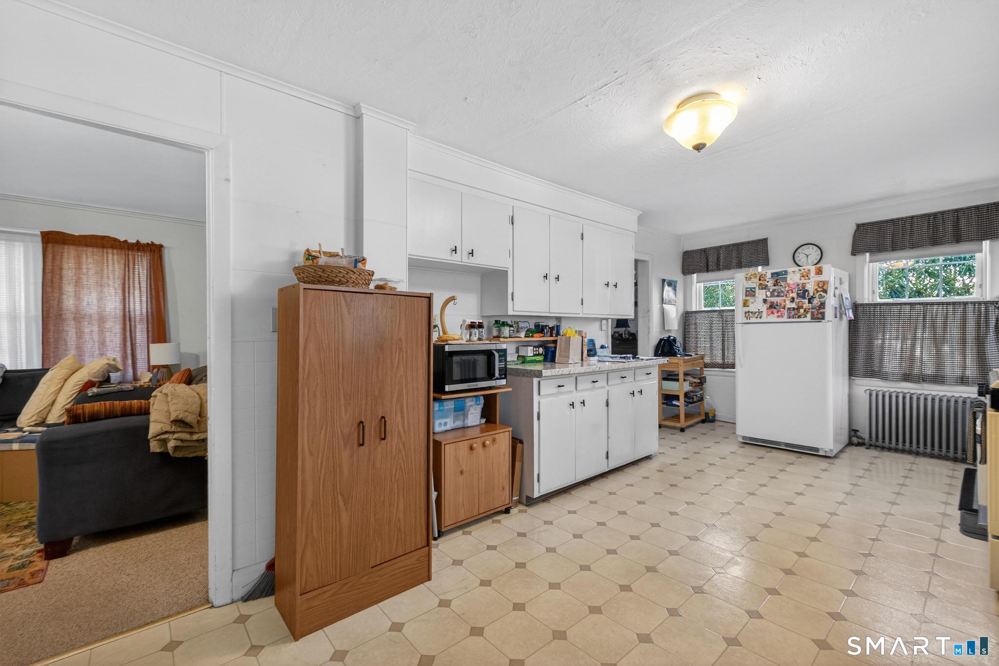 18 Broad Street Danielson, CT 06239 - Photo 25 of 38 a kitchen with refrigerator and cabinets