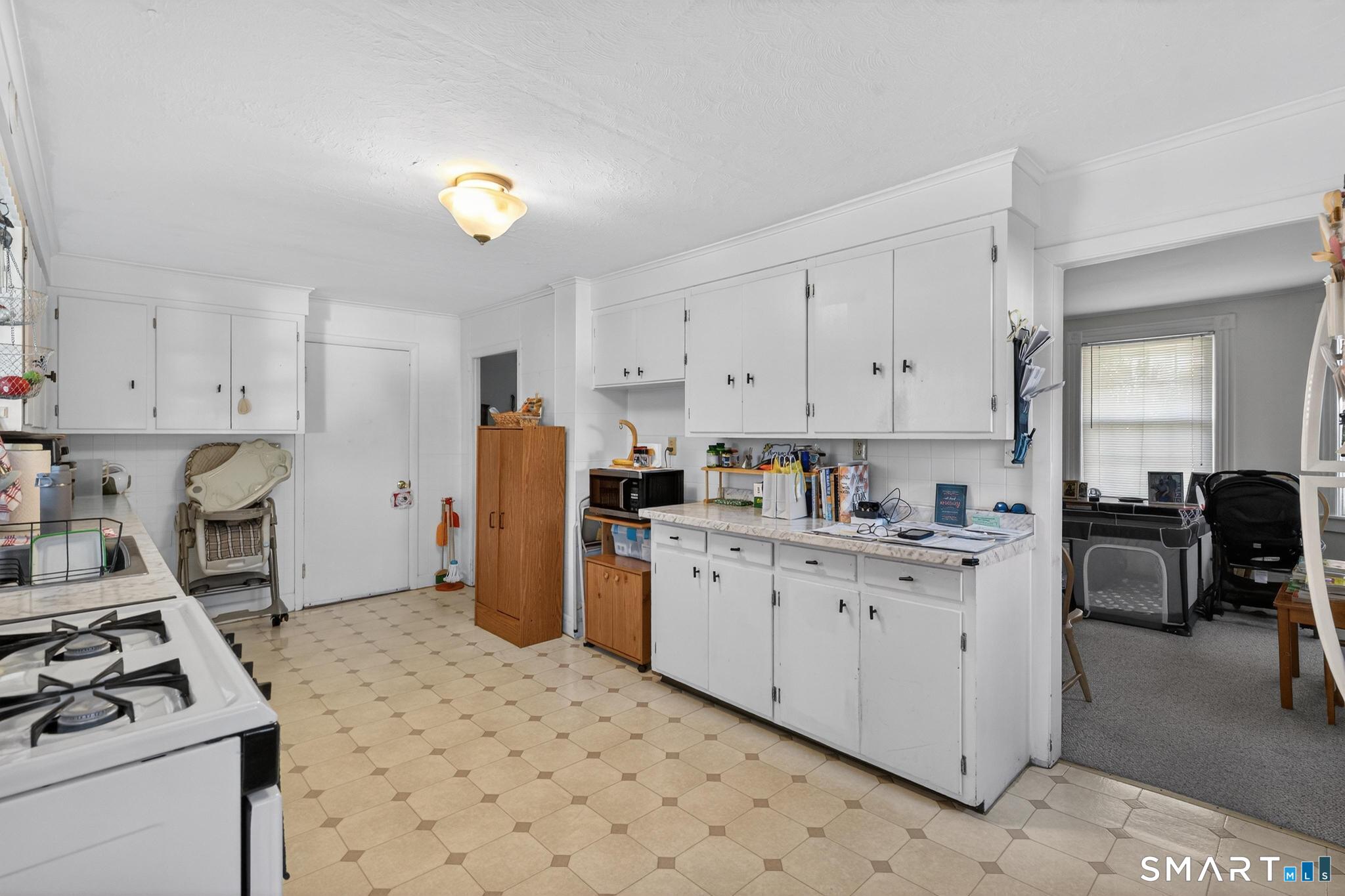 18 Broad Street Danielson, CT 06239 - Photo 26 of 38 a kitchen with a cabinets and appliances