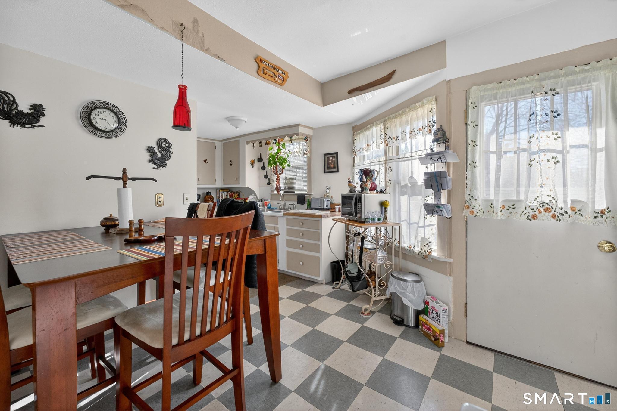 18 Broad Street Danielson, CT 06239 - Photo 27 of 38 a view of a dining room and livingroom with furniture wooden floor and a rug
