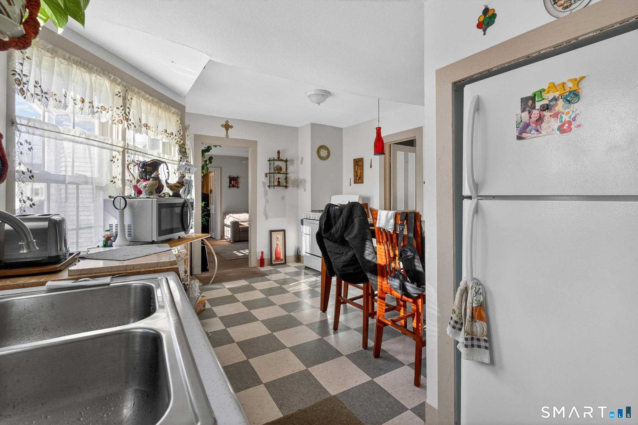 18 Broad Street Danielson, CT 06239 - Photo 28 of 38 a white refrigerator freezer sitting inside of a kitchen