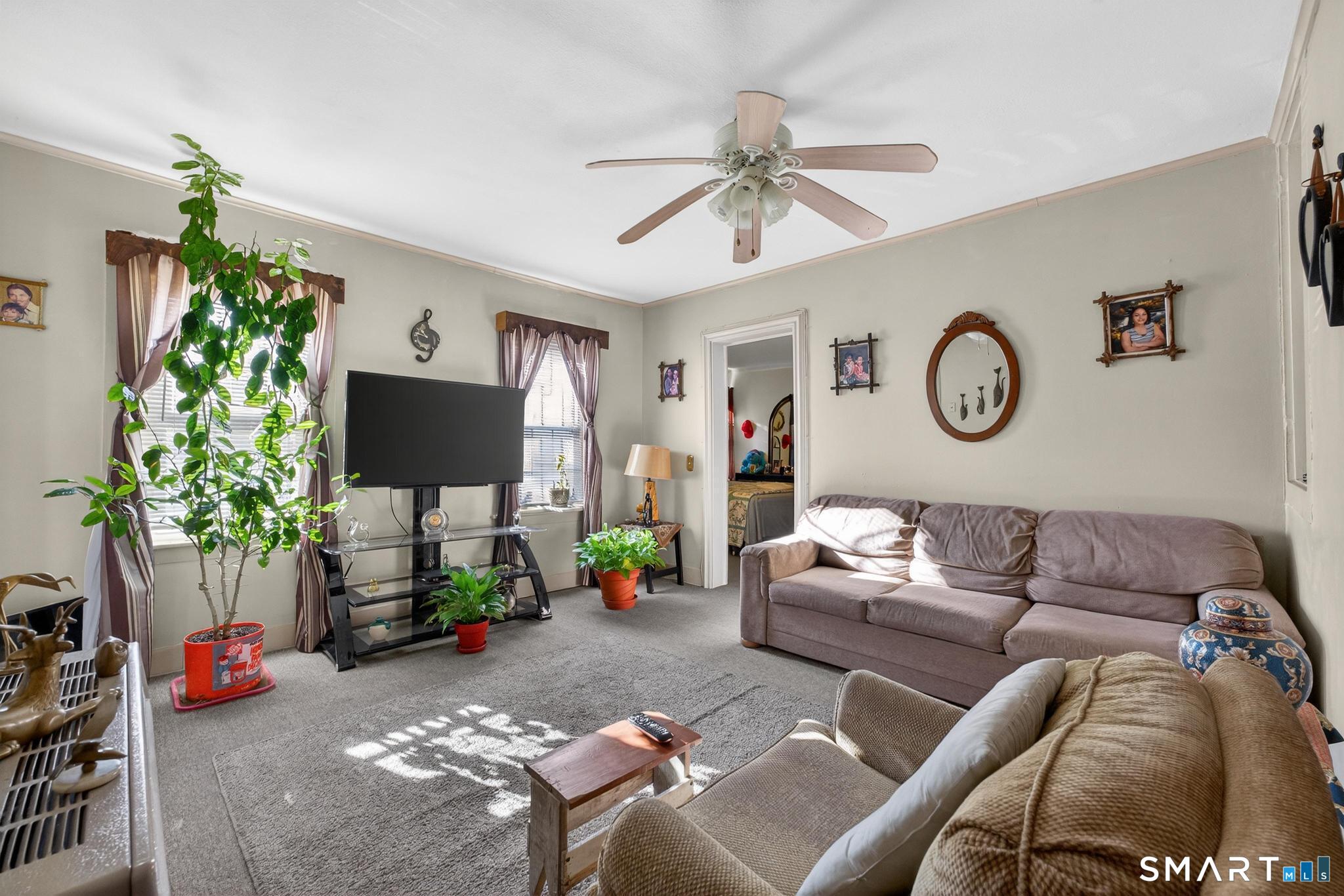 18 Broad Street Danielson, CT 06239 - Photo 34 of 38 a living room with furniture a flat screen tv and a potted plant