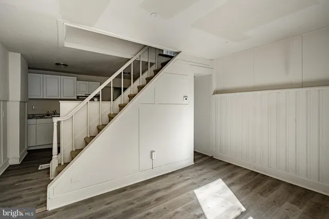 a view of entryway and hall with wooden floor